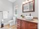 Bathroom featuring an undermount sink with granite counters, wood cabinets, and a white vessel sink at 2458 Genelia Dr, Claremont, NC 28610