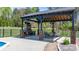 Covered outdoor patio with stone fireplace and lighting, perfect for entertaining at 2458 Genelia Dr, Claremont, NC 28610