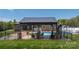 A backyard covered patio with stone fireplace, with outdoor seating and a barbecue at 2458 Genelia Dr, Claremont, NC 28610