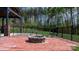 Outdoor fire pit area surrounded by a brick patio and a well-maintained backyard, ideal for gatherings and relaxation at 2458 Genelia Dr, Claremont, NC 28610