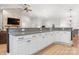 Open-concept kitchen with white cabinets, granite countertops and stainless appliances at 2458 Genelia Dr, Claremont, NC 28610