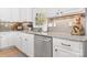 Bright kitchen with stainless steel dishwasher, granite countertops, and subway tile backsplash at 2458 Genelia Dr, Claremont, NC 28610