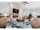 Open-concept living room with stone fireplace, hardwood floors, and natural light at 2458 Genelia Dr, Claremont, NC 28610
