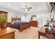 Comfortable main bedroom boasts a decorative wooden bed frame, ceiling fan, and carpet at 2458 Genelia Dr, Claremont, NC 28610