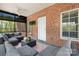 Inviting screened porch with brick accents, a ceiling fan, and outdoor furniture for comfortable lounging and entertaining at 2458 Genelia Dr, Claremont, NC 28610