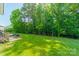 Large backyard with lush green grass and mature trees, perfect for recreation and relaxation at 2714 Woodlands Creek Dr, Monroe, NC 28110