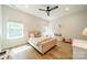 Bright, stylish bedroom with plush bed, hardwood floors, and two windows offering natural light at 2714 Woodlands Creek Dr, Monroe, NC 28110