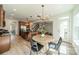 Bright dining area with modern chandelier next to kitchen featuring stainless steel appliances and wood floors at 2714 Woodlands Creek Dr, Monroe, NC 28110