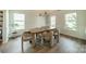 Bright and airy dining room featuring a modern chandelier, stylish furniture, and plenty of natural light at 2714 Woodlands Creek Dr, Monroe, NC 28110