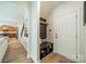 Hallway and entryway with built-in storage and bench, leading to the kitchen at 2714 Woodlands Creek Dr, Monroe, NC 28110