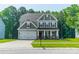 Charming two-story home featuring a well-manicured lawn and an attached two-car garage at 2714 Woodlands Creek Dr, Monroe, NC 28110