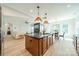 Stylish kitchen with a large island, modern lighting, stainless steel appliances, and an open floor plan at 2714 Woodlands Creek Dr, Monroe, NC 28110