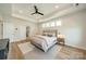 Bright main bedroom featuring a ceiling fan, hardwood floors, a stylish rug, and natural light at 2714 Woodlands Creek Dr, Monroe, NC 28110