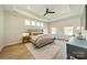 Spacious main bedroom with tray ceiling, multiple windows, and neutral decor at 2714 Woodlands Creek Dr, Monroe, NC 28110