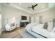 Bright main bedroom featuring a ceiling fan, hardwood floors, a stylish rug, and a cozy chair at 2714 Woodlands Creek Dr, Monroe, NC 28110