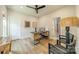 This well-lit office includes a desk, hardwood floors, a ceiling fan, and neutral decor at 2714 Woodlands Creek Dr, Monroe, NC 28110