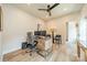 Well-lit home office features a modern wooden desk, comfortable chair, and stylish ceiling fan at 2714 Woodlands Creek Dr, Monroe, NC 28110