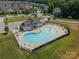 Aerial view of community pool area with pool, seating, and mature landscaping at 2714 Woodlands Creek Dr, Monroe, NC 28110