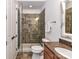 Bathroom with a glass-enclosed shower, granite countertop vanity, and tiled floors at 2810 Selwyn Ave # 104, Charlotte, NC 28209