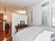 Bright bedroom with a view of the kitchen and hardwood floors at 2810 Selwyn Ave # 104, Charlotte, NC 28209
