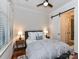 Cozy bedroom featuring a ceiling fan, a sliding barn door, and hardwood floors at 2810 Selwyn Ave # 104, Charlotte, NC 28209