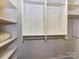 Walk-in closet with built-in shelving and closet rods at 2810 Selwyn Ave # 104, Charlotte, NC 28209
