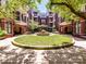 Courtyard with a water fountain, landscaping, and apartment buildings at 2810 Selwyn Ave # 104, Charlotte, NC 28209