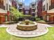 Courtyard with a fountain, landscaping, and apartment buildings at 2810 Selwyn Ave # 104, Charlotte, NC 28209