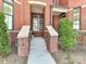 Inviting front entrance with brick accents and landscaped details at 2810 Selwyn Ave # 104, Charlotte, NC 28209