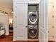 Laundry closet with a stacked washer and dryer at 2810 Selwyn Ave # 104, Charlotte, NC 28209