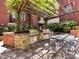 Enjoy outdoor dining with this built-in kitchen, featuring a pergola, multiple grills, and ample seating at 2810 Selwyn Ave # 104, Charlotte, NC 28209