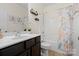 Well-lit bathroom with a dark wood vanity, shower-tub combination and decorative accents at 286 Mallard Head Dr, Rock Hill, SC 29732