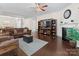 Inviting living room features a cozy fireplace, ceiling fan, and an entertainment center with display shelves at 286 Mallard Head Dr, Rock Hill, SC 29732
