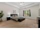 Serene main bedroom with tray ceiling, plush carpet, and a large window at 286 Mallard Head Dr, Rock Hill, SC 29732