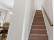 Carpeted staircase with a wood handrail, leading to the upper level of the home at 286 Mallard Head Dr, Rock Hill, SC 29732