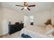 Cozy main bedroom with ceiling fan, carpet floors, dresser with lamps, and ensuite bathroom access at 314 Sunnywood Ln, Charlotte, NC 28270
