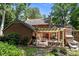 Private backyard showcasing a brick patio with pergola, fireplace, and lush landscaping at 3209 Sedgefield Rd, Statesville, NC 28625