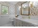Bathroom featuring floral wallpaper, gold hardware, and tiled floors at 3209 Sedgefield Rd, Statesville, NC 28625