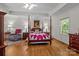 Spacious bedroom featuring a four-poster bed, sitting area, and hardwood floors at 3209 Sedgefield Rd, Statesville, NC 28625