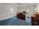 Bright bedroom with three large windows and classic wood furnishings at 3209 Sedgefield Rd, Statesville, NC 28625