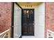 Elegant black front door with glass accents and brass hardware at 3209 Sedgefield Rd, Statesville, NC 28625