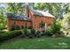 Charming red brick home with mature landscaping and a well-manicured lawn at 3209 Sedgefield Rd, Statesville, NC 28625