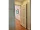 Hallway featuring hardwood floors and floral wallpaper at 3209 Sedgefield Rd, Statesville, NC 28625