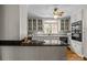 Bright kitchen with black countertops, white cabinets, and stainless steel appliances at 3209 Sedgefield Rd, Statesville, NC 28625