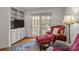 Cozy living room featuring a built-in bookcase, armchair, and view of the patio at 3209 Sedgefield Rd, Statesville, NC 28625