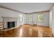 Bright living room with hardwood floors, fireplace, and large windows at 3209 Sedgefield Rd, Statesville, NC 28625