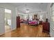 Spacious bedroom featuring a four-poster bed, sitting area, and hardwood floors at 3209 Sedgefield Rd, Statesville, NC 28625