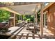 Expansive brick patio with a fireplace, multiple seating areas, and an outdoor cooking area for entertaining guests at 3209 Sedgefield Rd, Statesville, NC 28625