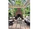 Inviting outdoor brick patio featuring a cozy brick fireplace and comfortable seating area for relaxation at 3209 Sedgefield Rd, Statesville, NC 28625