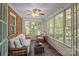 Bright sunroom features brick floors, wicker furniture, lots of windows and beautiful views at 3209 Sedgefield Rd, Statesville, NC 28625